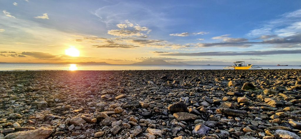 A rocky shoreline at sunset
