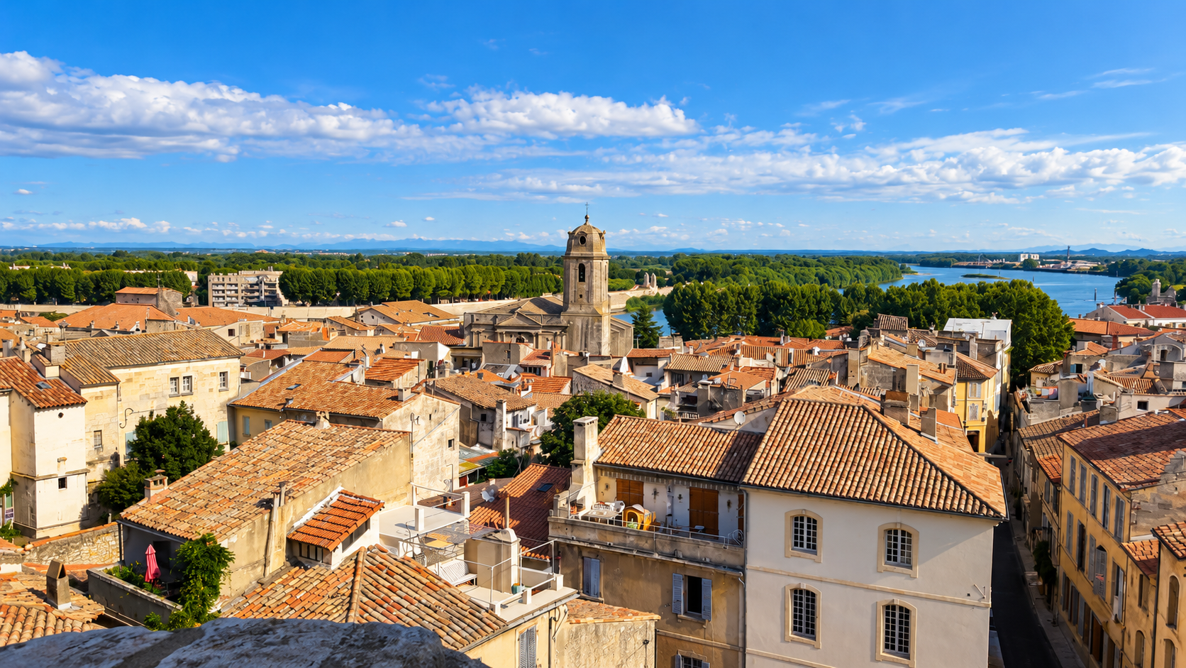 View across the rooftops of Arles toward the river